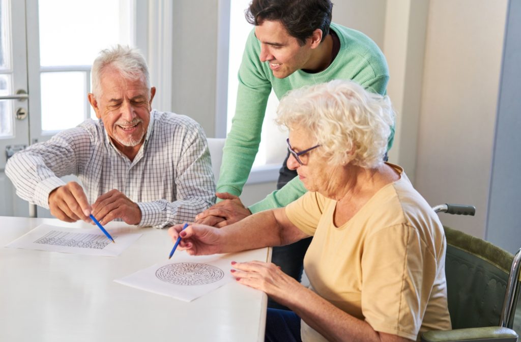 A senior couple trains their cognitive skills by finishing puzzles.