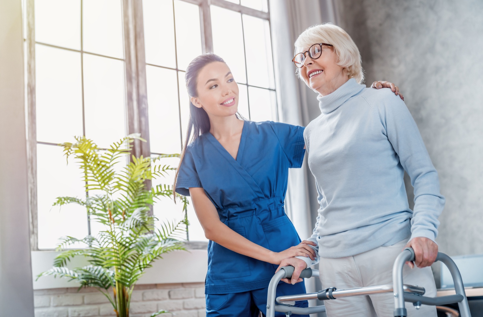 A nurse assisting a senior during recovery after a hip fracture.