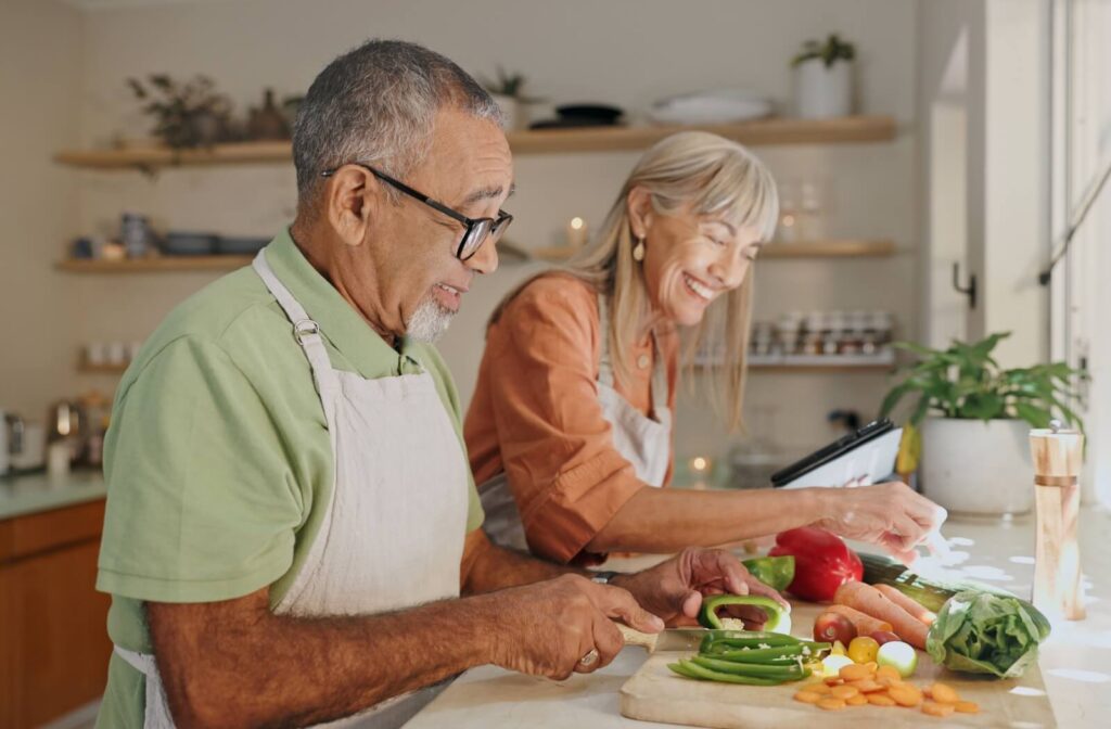 Two older adults participate in a collaborative cooking group.